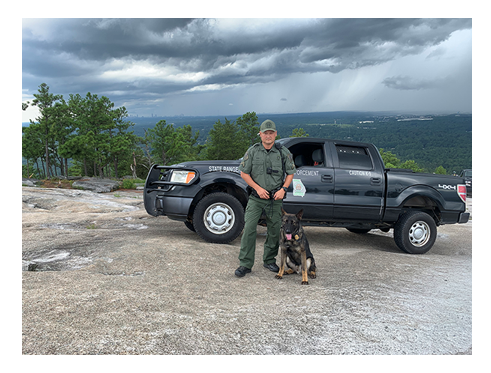 K-9, handler, and truck on top of Stone Mountain