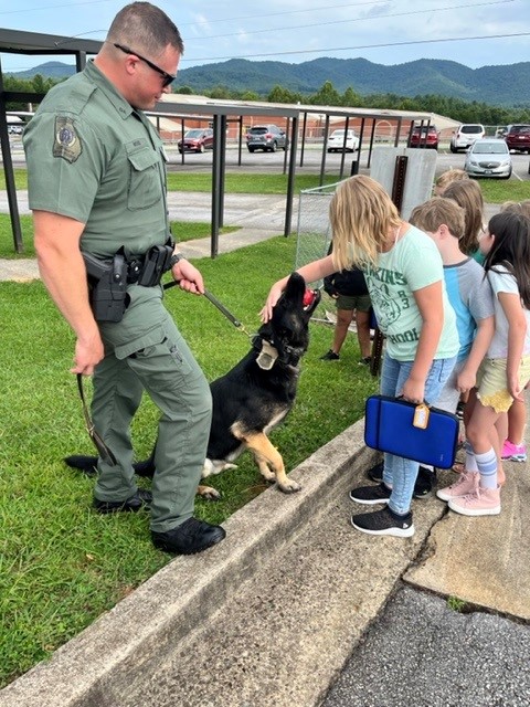 K-9 and handler with a group of school children.