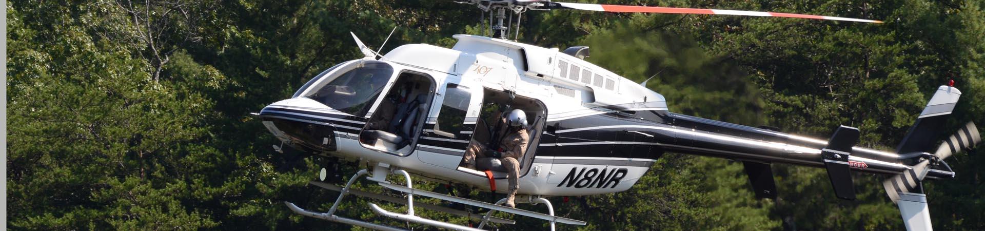 DNR helicopter in long-line rescue training